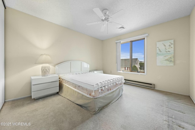 carpeted bedroom featuring a baseboard heating unit, a textured ceiling, and ceiling fan