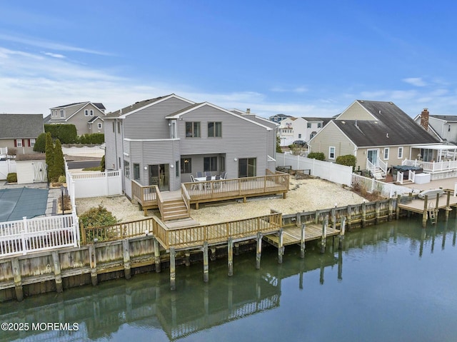 rear view of property with a deck with water view