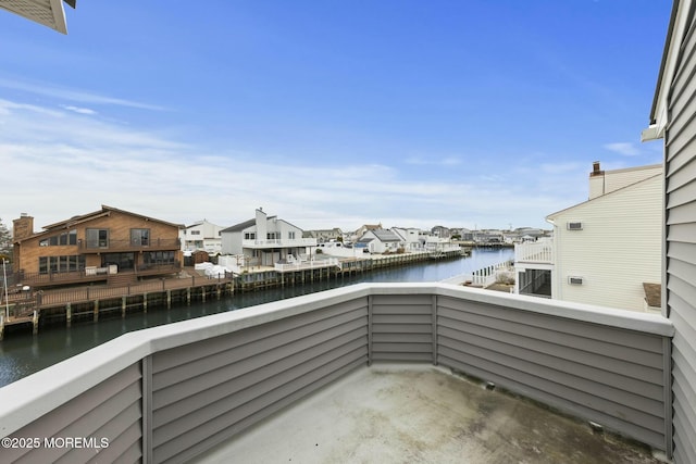 view of patio / terrace featuring a balcony and a water view