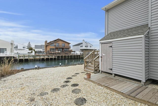 view of yard with a water view and a storage unit