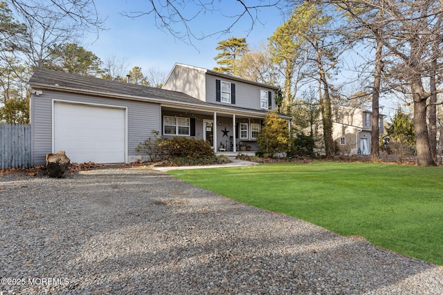 front of property featuring a porch, a garage, and a front yard