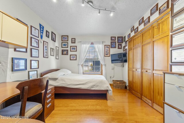 18 Tall Oaks Ct, Old Bridge, NJ 08857 - bedroom with a textured ceiling and light wood-style floors