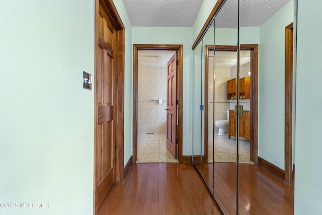 18 Tall Oaks Ct, Old Bridge, NJ 08857 - corridor with a textured ceiling, hardwood / wood-style floors, and baseboards