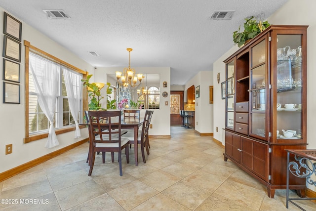 18 Tall Oaks Ct, Old Bridge, NJ 08857 - dining area with a chandelier, a textured ceiling, baseboards, and light tile patterned flooring