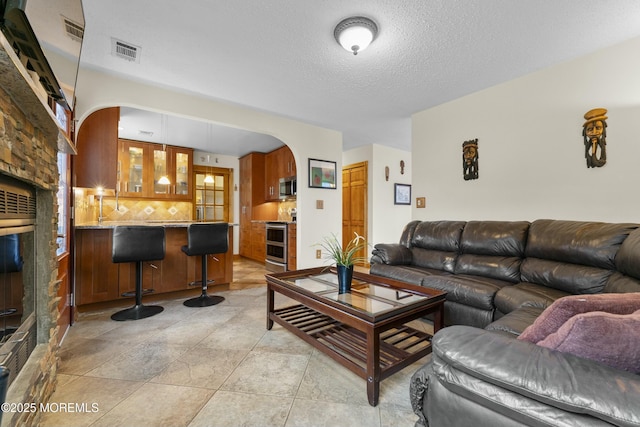 18 Tall Oaks Ct, Old Bridge, NJ 08857 - living area with arched walkways and a textured ceiling