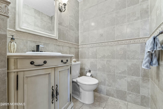 18 Tall Oaks Ct, Old Bridge, NJ 08857 - bathroom featuring tile walls, tile patterned flooring, toilet, and vanity
