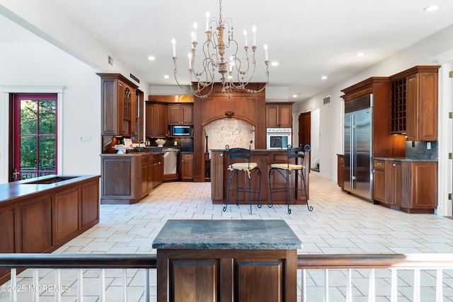 kitchen featuring stainless steel appliances, a center island, pendant lighting, and backsplash