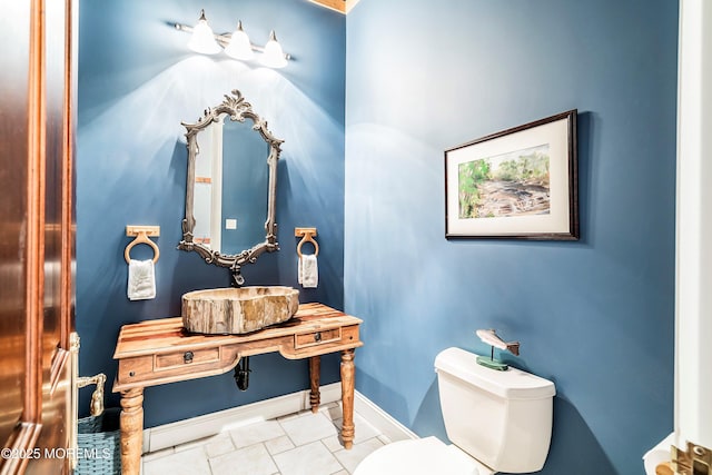 bathroom with tile patterned flooring, sink, and toilet