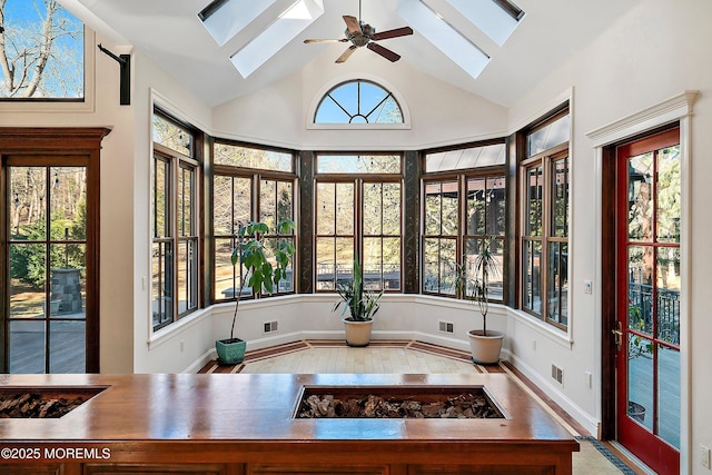 sunroom featuring ceiling fan and lofted ceiling with skylight