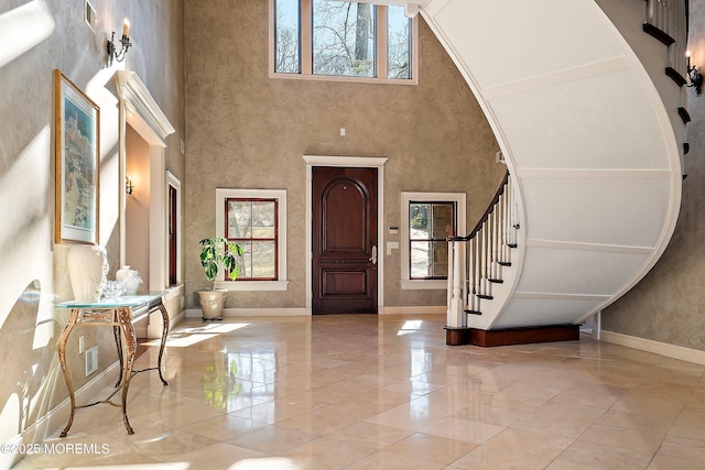 entrance foyer featuring a towering ceiling