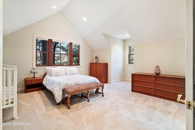 carpeted bedroom with lofted ceiling