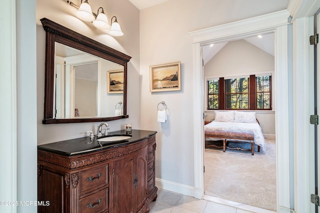 bathroom with vanity, vaulted ceiling, and tile patterned floors