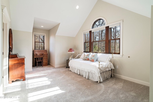 bedroom featuring high vaulted ceiling and light colored carpet