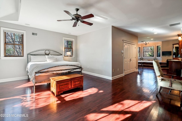 bedroom with ceiling fan and dark hardwood / wood-style flooring