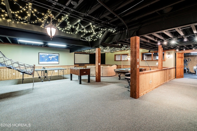 basement featuring wooden walls and carpet