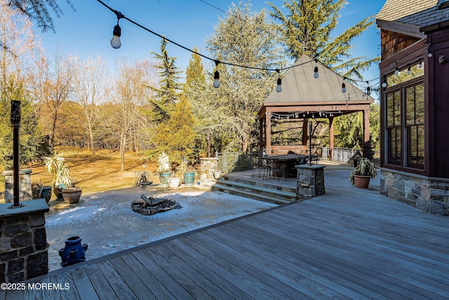 deck with a gazebo and an outdoor fire pit