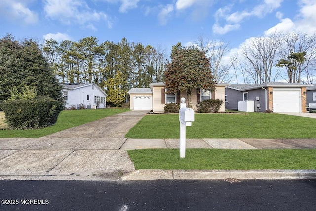 ranch-style house featuring a garage and a front lawn