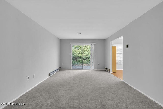 carpeted empty room with a baseboard radiator