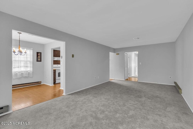 carpeted spare room with an inviting chandelier, a baseboard radiator, and washer / dryer