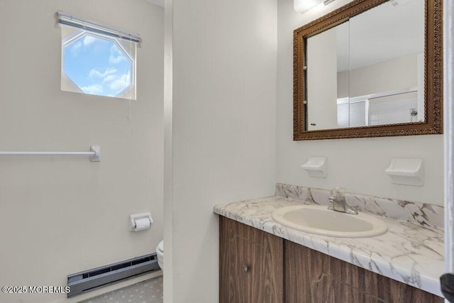 bathroom featuring vanity, a baseboard radiator, a shower with shower door, and toilet