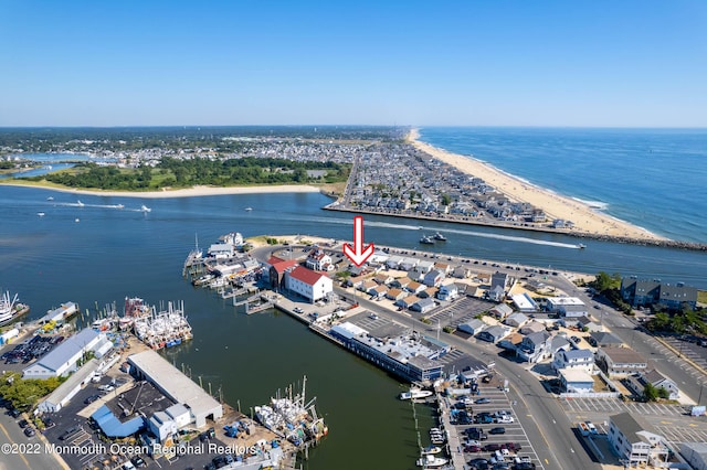 birds eye view of property featuring a water view and a beach view