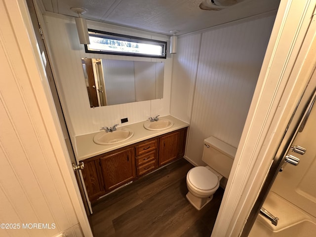 bathroom featuring hardwood / wood-style flooring, vanity, and toilet