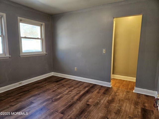 empty room featuring dark wood-type flooring