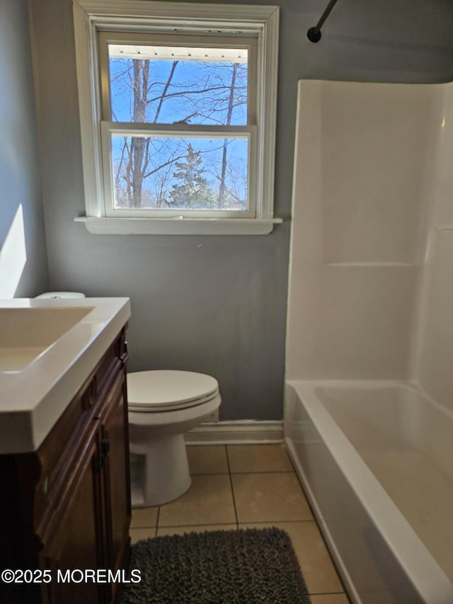 full bathroom with shower / tub combination, tile patterned floors, toilet, and vanity