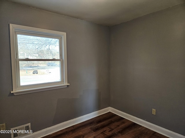 unfurnished room with dark hardwood / wood-style floors