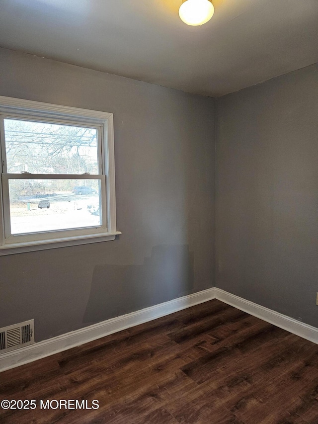 empty room with hardwood / wood-style flooring