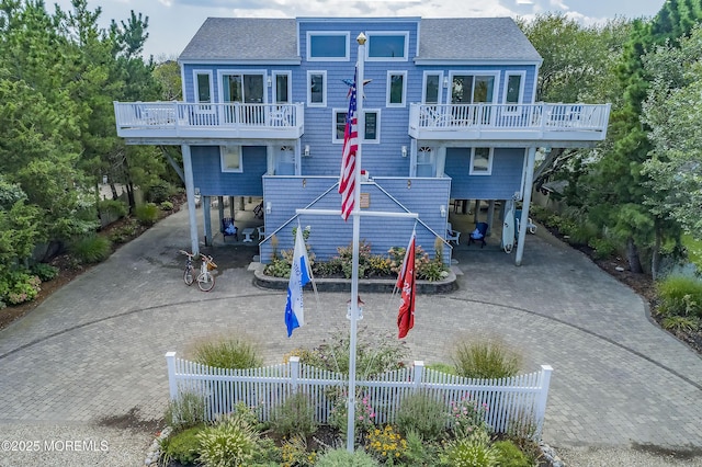 rear view of house with a carport and a balcony