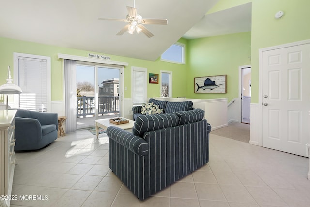 living room featuring ceiling fan, high vaulted ceiling, and light tile patterned floors