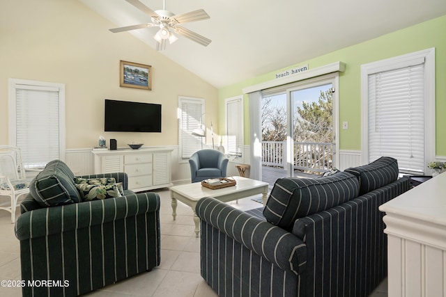 living room featuring ceiling fan, vaulted ceiling, and light tile patterned floors