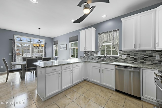 kitchen featuring pendant lighting, sink, stainless steel appliances, tasteful backsplash, and white cabinets