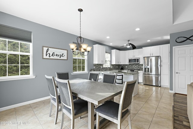 tiled dining space with an inviting chandelier