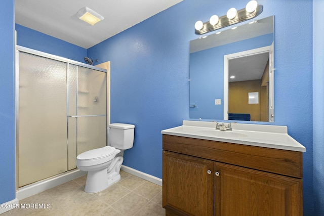 bathroom with tile patterned flooring, vanity, toilet, and walk in shower