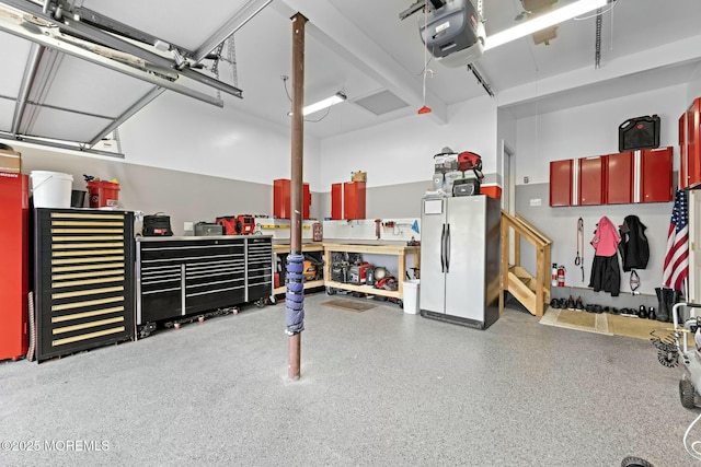 garage featuring a garage door opener and fridge