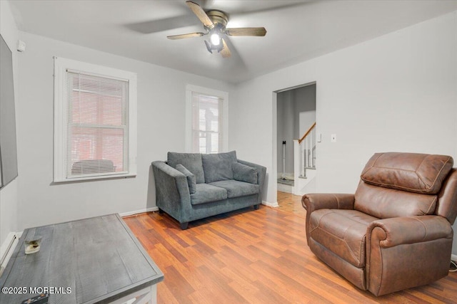 living room featuring hardwood / wood-style flooring and ceiling fan