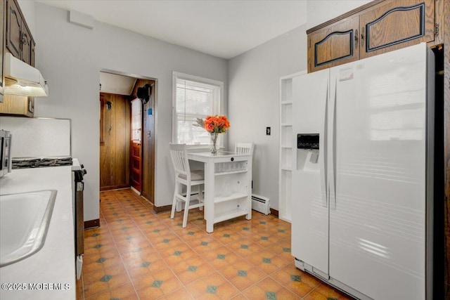 kitchen with dark brown cabinetry, sink, white fridge with ice dispenser, and baseboard heating