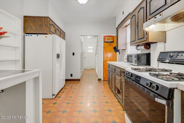 kitchen with white appliances, dark brown cabinetry, and light tile patterned floors