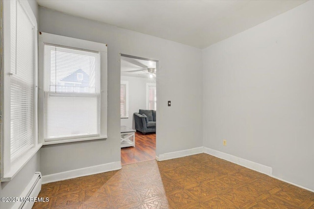 unfurnished room featuring a baseboard radiator