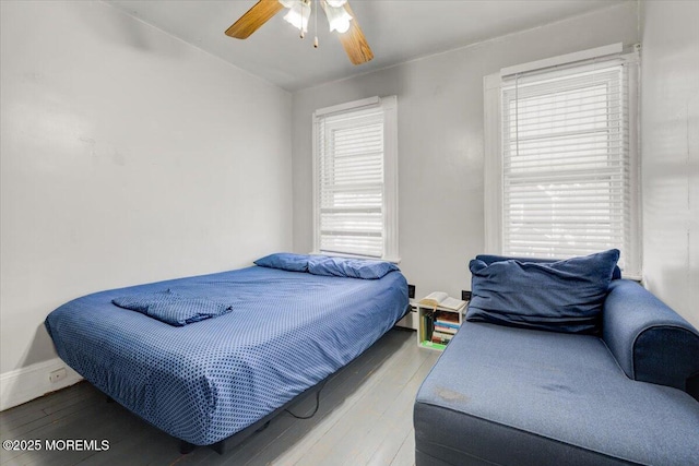 bedroom with wood-type flooring and ceiling fan