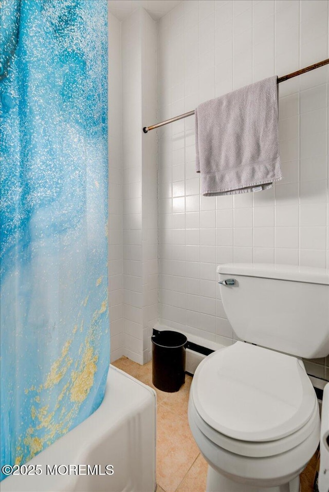 bathroom featuring tile patterned flooring, tile walls, shower / bath combination with curtain, and toilet