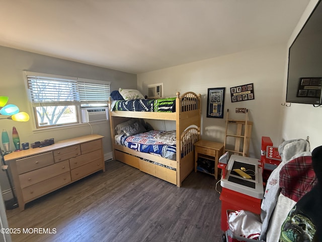 bedroom featuring a baseboard heating unit, dark hardwood / wood-style floors, and cooling unit