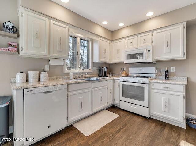 kitchen featuring white appliances, dark hardwood / wood-style flooring, sink, and white cabinets