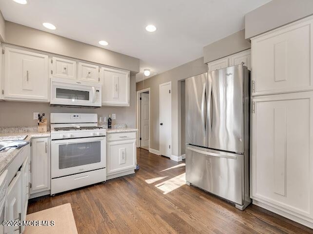 kitchen with white cabinetry, white appliances, and dark wood-type flooring