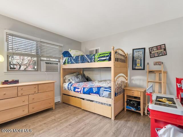 bedroom featuring hardwood / wood-style flooring and cooling unit