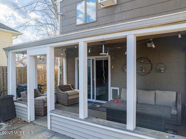 deck featuring a sunroom and an outdoor hangout area