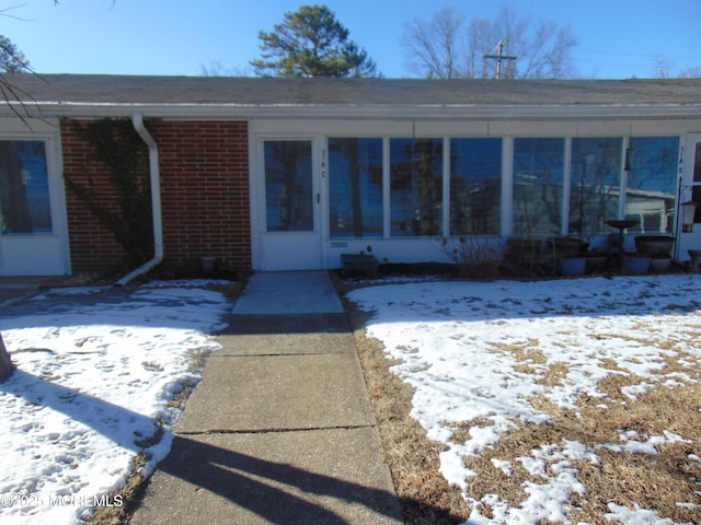 view of snow covered property entrance