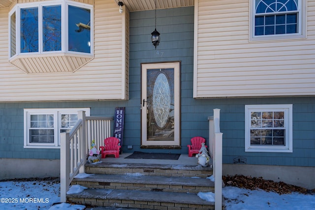 view of snow covered property entrance